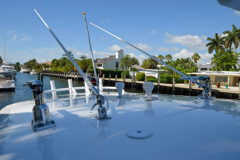 Quid Pro Quo Yacht Photos Pics 2013 Intrepid 300 Center Console boat docked in a scenic canal setting.