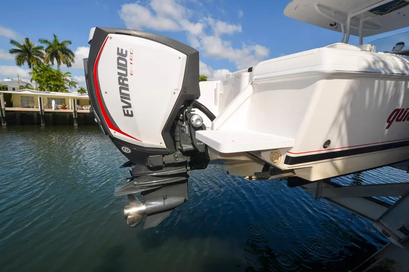 Quid Pro Quo Yacht Photos Pics 2013 Intrepid 300 Center Console with Evinrude E-TEC engine by the water.