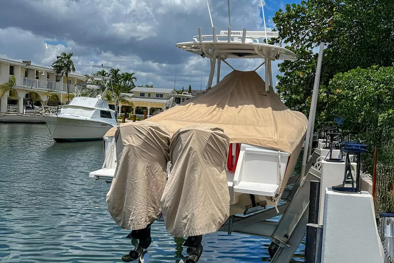 Quid Pro Quo Yacht Photos Pics 2013 Intrepid 300 Center Console boat covered and docked by waterfront homes.
