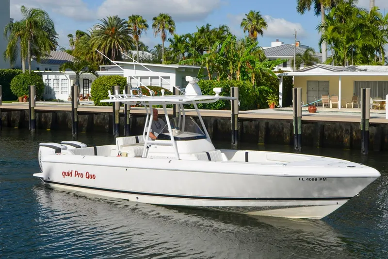 Quid Pro Quo Yacht Photos Pics 2013 Intrepid 300 Center Console boat cruising near waterfront homes.