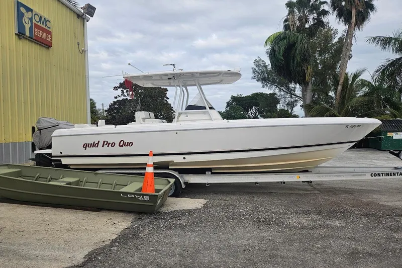 Quid Pro Quo Yacht Photos Pics 2013 Intrepid 300 Center Console boat on trailer near service building.
