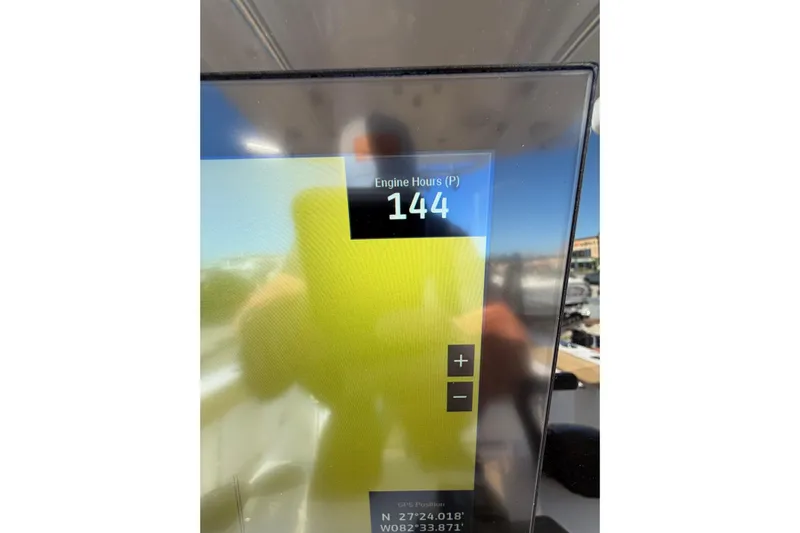  Yacht Photos Pics Display screen showing 144 engine hours on 2023 Sportsman Heritage 241 Center Console.