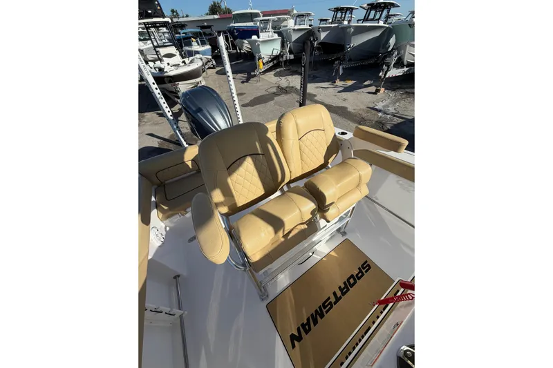  Yacht Photos Pics 2023 Sportsman Heritage 241 Center Console with tan seating, displayed among other boats.