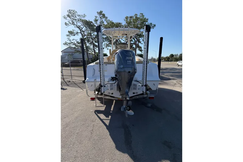  Yacht Photos Pics 2023 Sportsman Heritage 241 Center Console boat with powerful 300 V6 engine, parked outdoors.