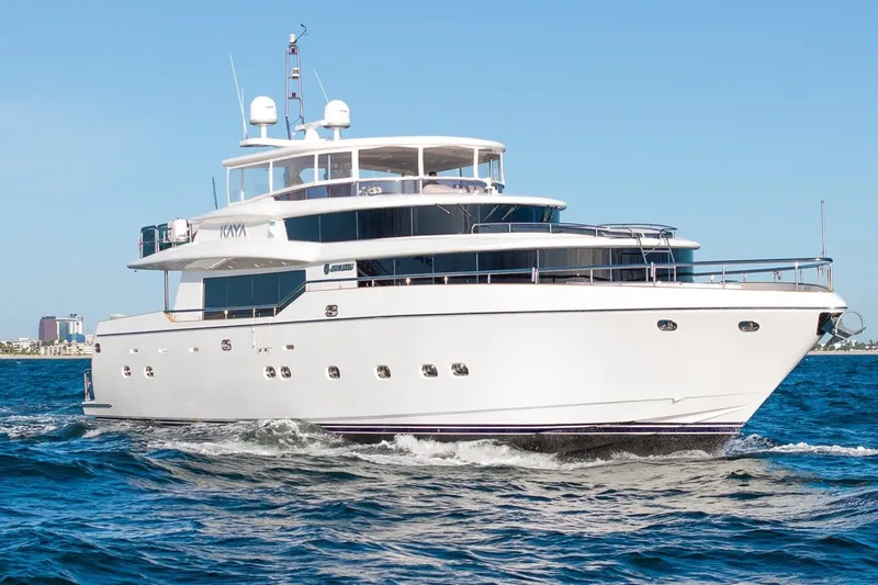 Kaya Yacht Photos Pics Luxurious 2003 Johnson 87' Motor Yacht cruising on open water.