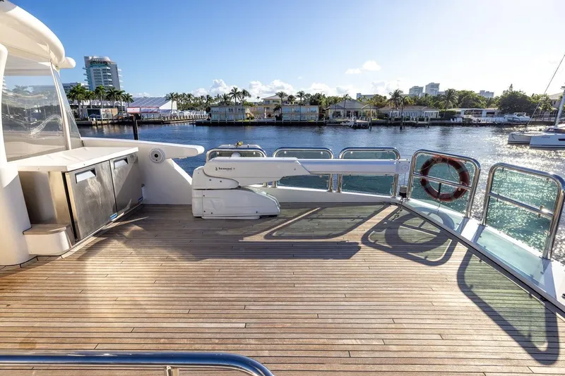 Kaya Yacht Photos Pics Luxurious 2003 Johnson 87' Motor Yacht deck with scenic waterfront view.