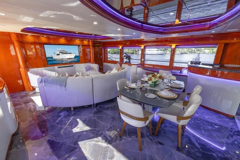 Kaya Yacht Photos Pics Luxurious interior of 2003 Johnson 87' Motor Yacht with elegant dining and seating area.