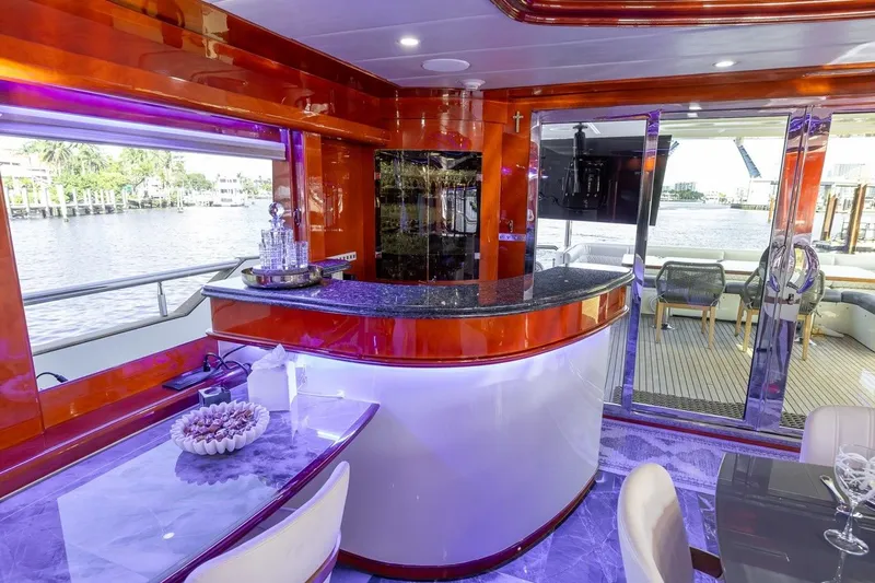 Kaya Yacht Photos Pics Luxurious interior of a 2003 Johnson 87' Motor Yacht with elegant bar and waterfront view.