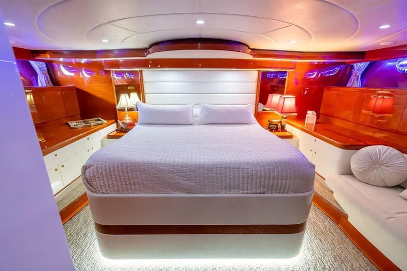 Kaya Yacht Photos Pics Luxurious bedroom interior of 2003 Johnson 87' Motor Yacht with elegant lighting and wood finishes.