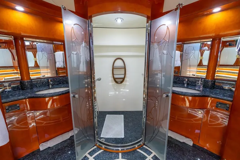 Kaya Yacht Photos Pics Luxurious bathroom on 2003 Johnson 87' Motor Yacht with elegant wood and glass design.