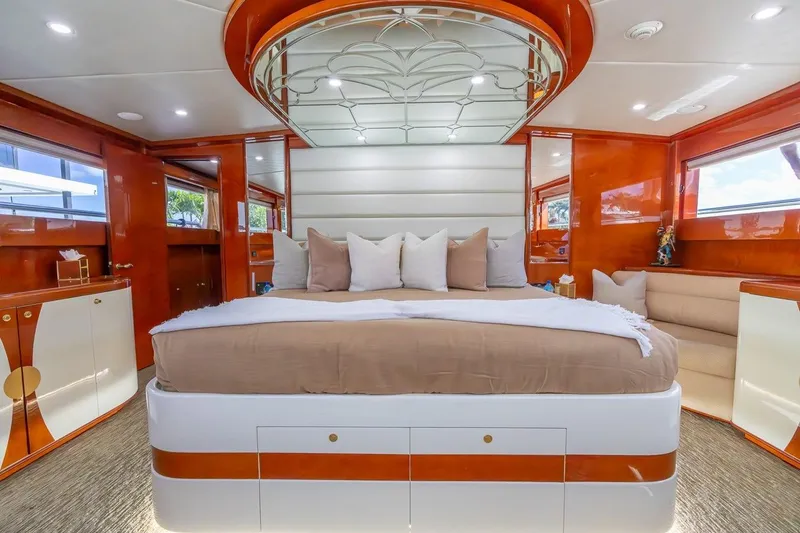 Kaya Yacht Photos Pics Luxurious bedroom interior of 2003 Johnson 87' Motor Yacht with elegant wood finishes and plush bedding.