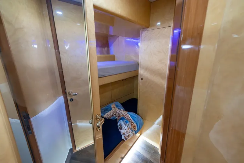 Kaya Yacht Photos Pics Interior of 2003 Johnson 87' Motor Yacht with cozy bunk beds and wooden finish.