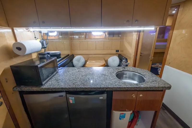 Kaya Yacht Photos Pics Luxurious kitchen area in a 2003 Johnson 87' Motor Yacht with granite countertop.