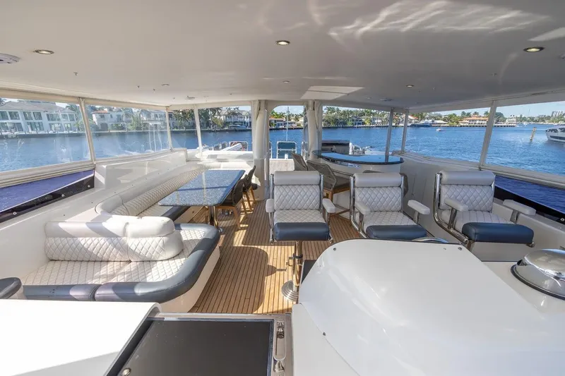 Kaya Yacht Photos Pics Luxurious interior of 2003 Johnson 87' Motor Yacht with elegant seating and scenic water views.