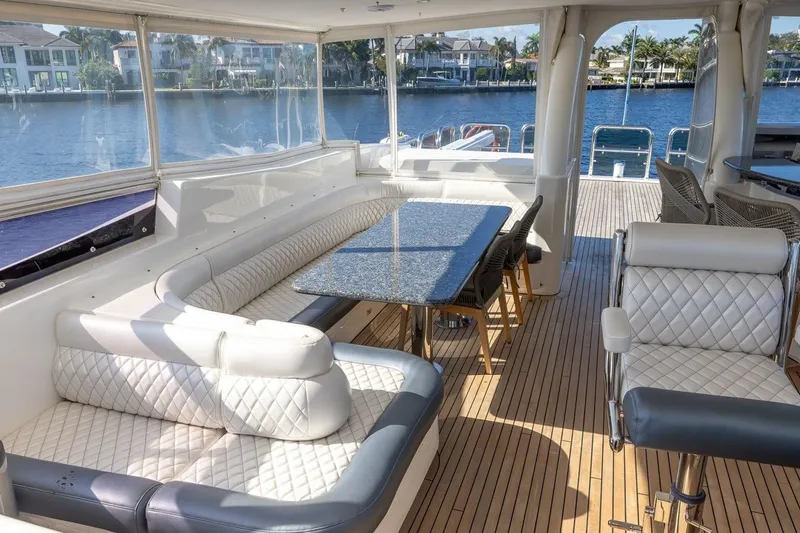 Kaya Yacht Photos Pics Luxurious interior of 2003 Johnson 87' Motor Yacht with elegant seating and waterfront view.