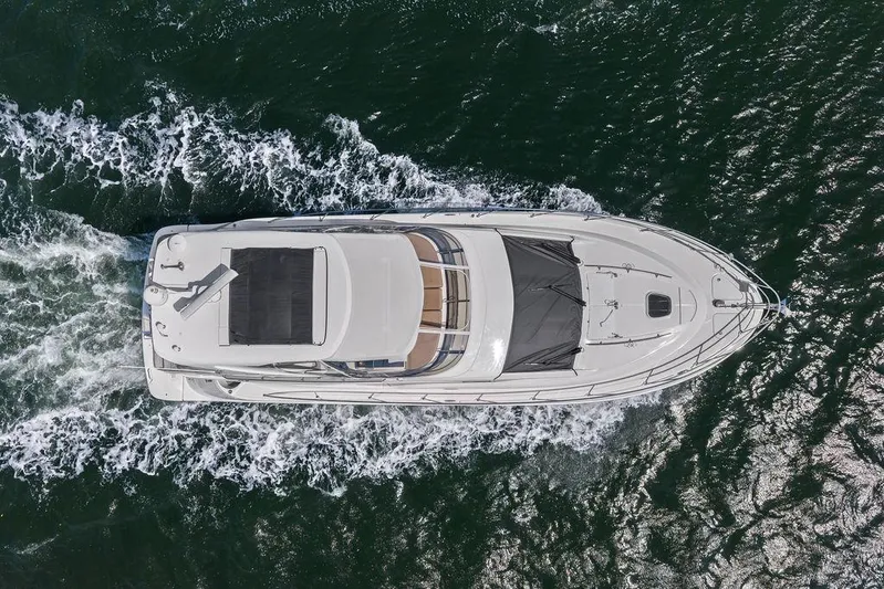 Ern'd It Yacht Photos Pics Aerial view of 2017 Sea Ray Fly 510 yacht cruising on open water.