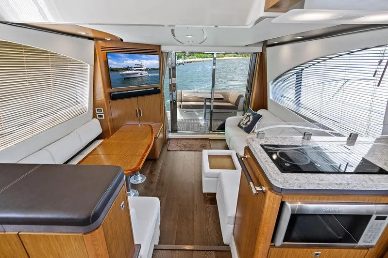Ern'd It Yacht Photos Pics Luxurious interior of 2017 Sea Ray Fly 510 yacht with modern kitchen and seating area.