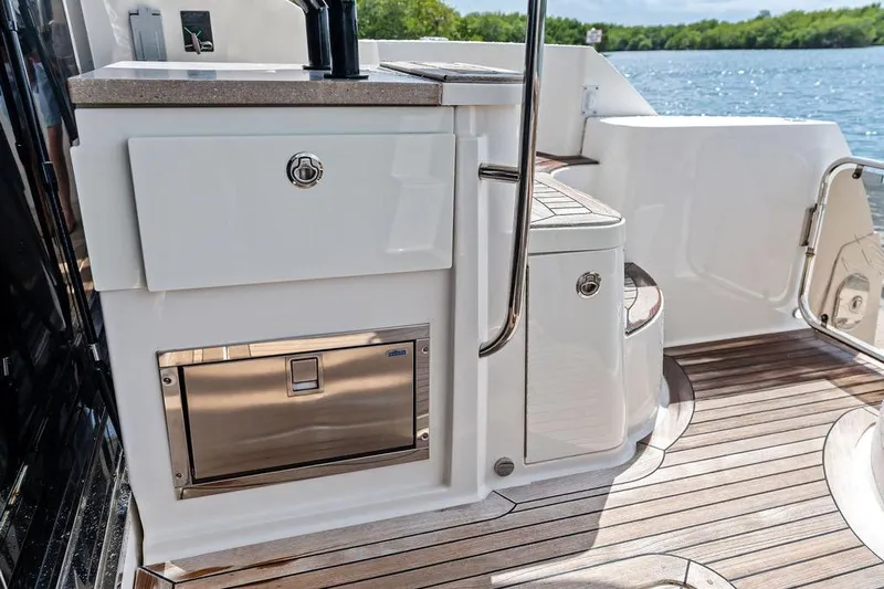 Ern'd It Yacht Photos Pics Luxurious 2017 Sea Ray Fly 510 yacht deck with sleek cabinetry and scenic water view.