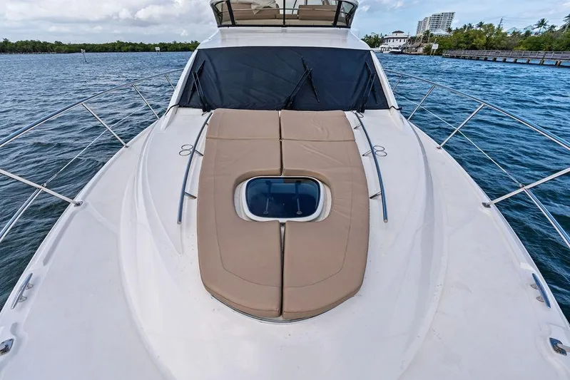 Ern'd It Yacht Photos Pics 2017 Sea Ray Fly 510 yacht with sunpad on deck, cruising on calm waters.
