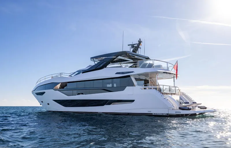  Yacht Photos Pics 2025 Sunseeker 100 Yacht cruising on open water under clear blue sky.