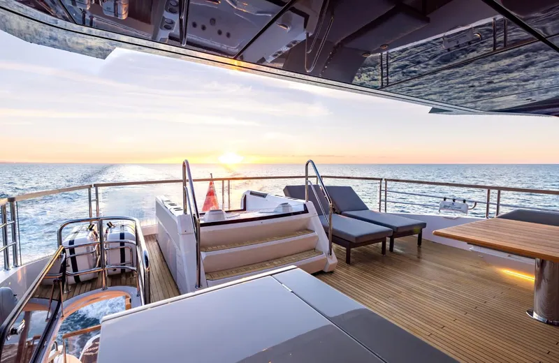  Yacht Photos Pics Luxurious Sunseeker 100 Yacht 2025 with elegant deck and stunning ocean sunset view.