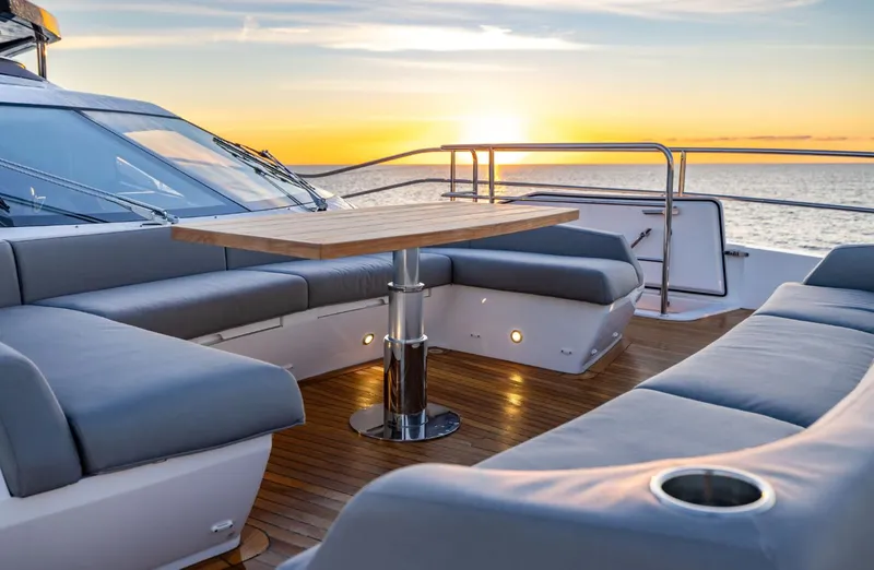  Yacht Photos Pics Luxurious Sunseeker 100 Yacht 2025 deck with sunset view, featuring elegant seating and table.