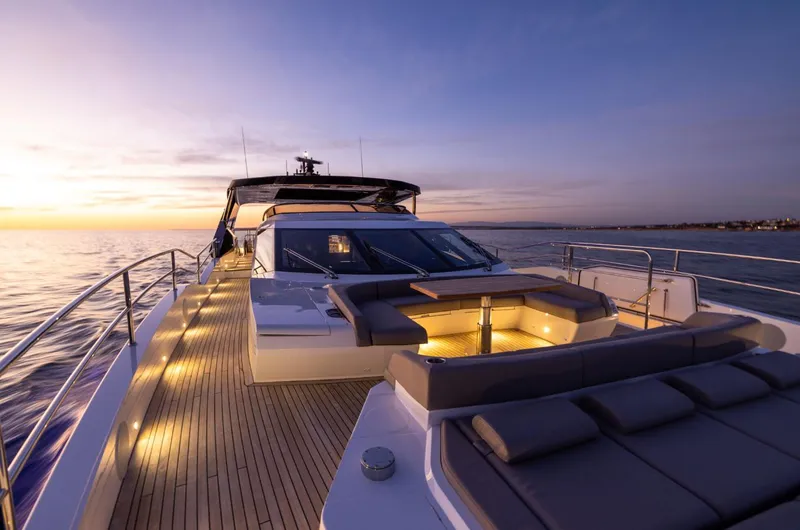  Yacht Photos Pics Luxurious 2025 Sunseeker 100 Yacht at sunset, featuring elegant deck lighting and modern design.
