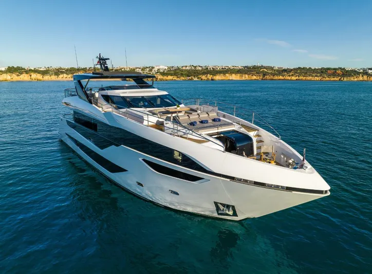  Yacht Photos Pics Luxurious 2025 Sunseeker 100 Yacht cruising on serene blue waters.