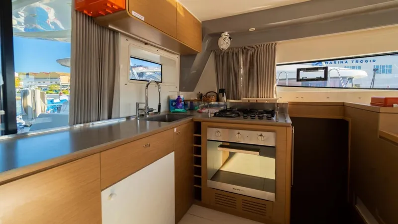  Yacht Photos Pics Modern kitchen interior on 2023 Excess 15 yacht, featuring stove, oven, and sleek cabinetry.