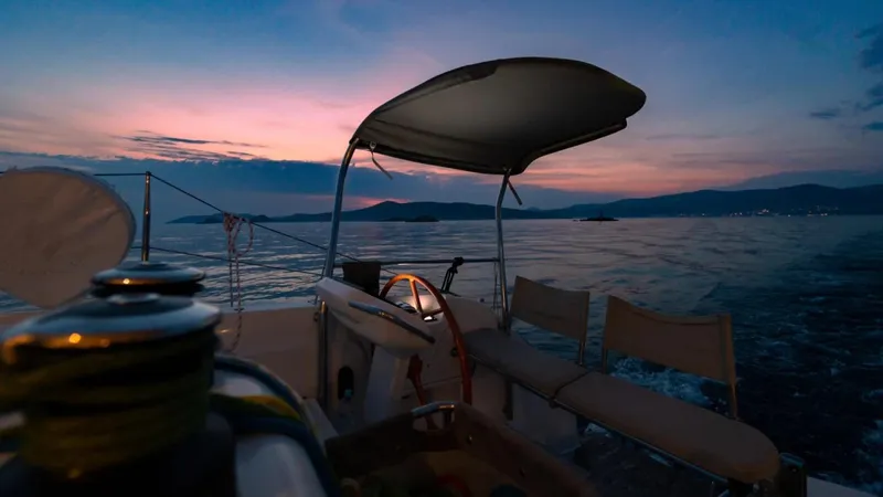  Yacht Photos Pics Sailboat "Excess 15" at sunset, 2023 model, cruising on calm waters.