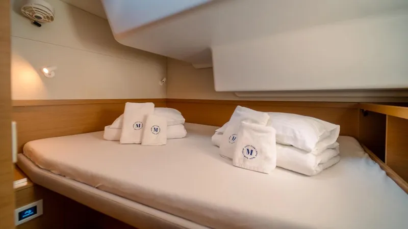  Yacht Photos Pics Luxurious cabin interior of 2023 Excess 15 yacht with neatly arranged bedding.