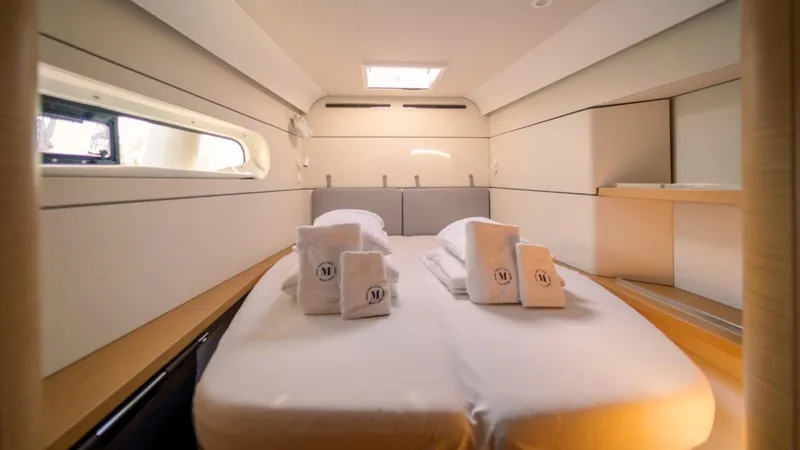  Yacht Photos Pics Luxurious cabin interior of 2023 Excess 15 yacht with neatly arranged towels on bed.