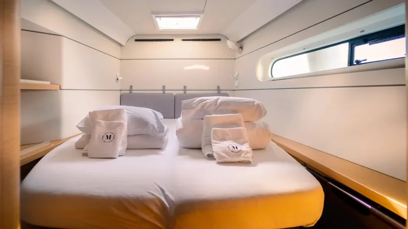  Yacht Photos Pics Luxurious cabin interior of 2023 Excess 15 yacht with neatly arranged bedding.