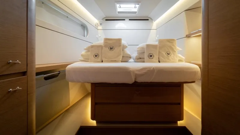  Yacht Photos Pics Luxurious cabin interior of 2023 Excess 15 yacht with neatly arranged towels.