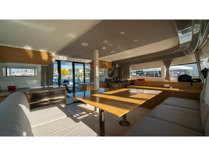  Yacht Photos Pics Luxurious interior of 2023 Excess 15 catamaran with modern seating and dining area.