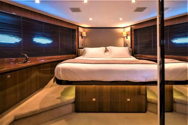  Yacht Photos Pics Luxurious bedroom interior of 2012 Princess 85 Motor Yacht with elegant lighting and wood finishes.