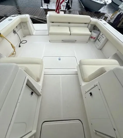 First Light II Yacht Photos Pics 1998 Tiara Yachts 3500 Open boat deck with cushioned seating and storage compartments.