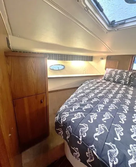 First Light II Yacht Photos Pics 1998 Tiara Yachts 3500 Open cabin interior with bed and wooden cabinetry.