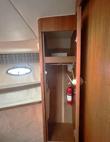 First Light II Yacht Photos Pics 1998 Tiara Yachts 3500 Open interior cabinet with fire extinguisher.