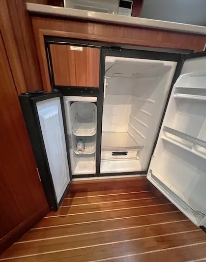 First Light II Yacht Photos Pics 1998 Tiara Yachts 3500 Open refrigerator, open doors, wooden flooring, interior view.