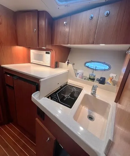 First Light II Yacht Photos Pics 1998 Tiara Yachts 3500 Open galley with sink, stove, and microwave.