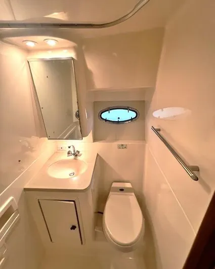 First Light II Yacht Photos Pics 1998 Tiara Yachts 3500 Open bathroom with sink, toilet, and porthole window.