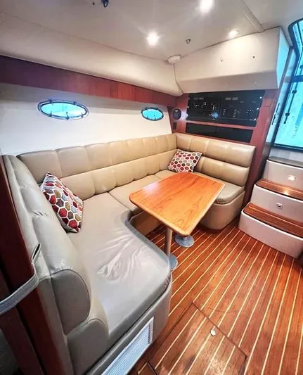 First Light II Yacht Photos Pics 1998 Tiara Yachts 3500 Open interior with leather seating and wooden table.