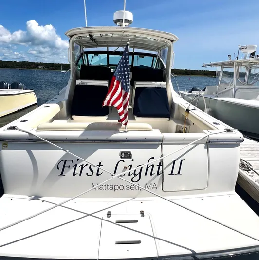 First Light II Yacht Photos Pics 1998 Tiara Yachts 3500 Open docked, displaying American flag, named "First Light II."