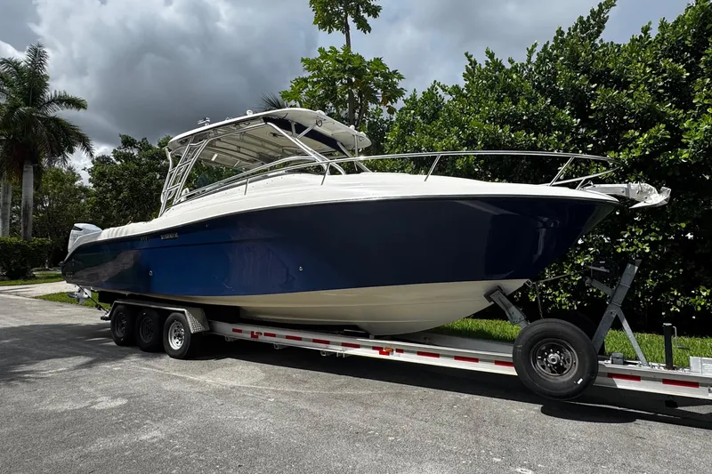  Yacht Photos Pics 2007 Hydra-Sports Vector 3300 VX boat on trailer, surrounded by lush greenery.