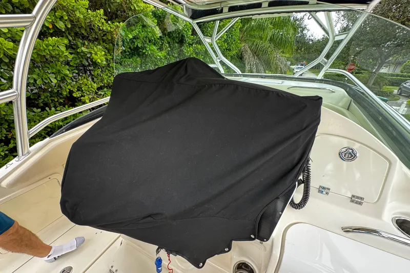  Yacht Photos Pics 2007 Hydra-Sports Vector 3300 VX boat interior with covered console and lush greenery background.
