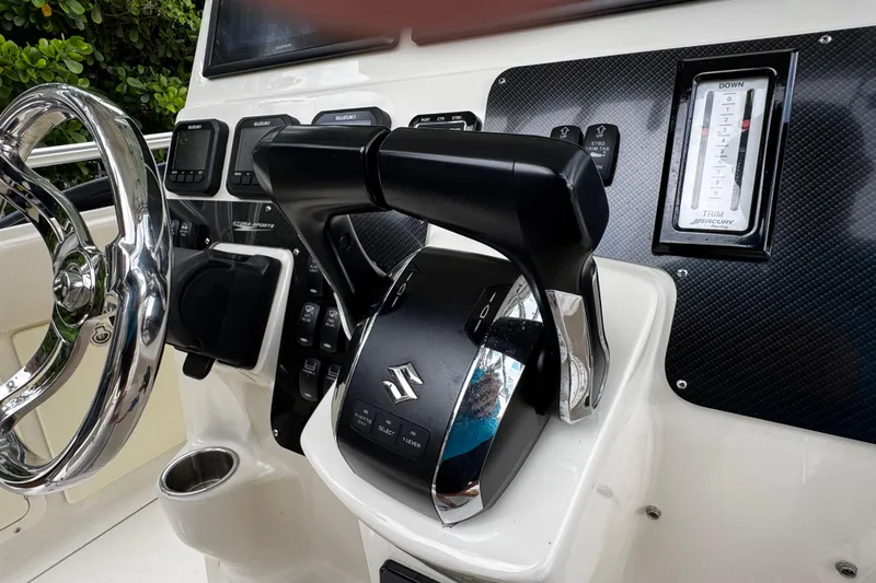  Yacht Photos Pics 2007 Hydra-Sports Vector 3300 VX boat dashboard with Suzuki controls and Mercury trim gauge.