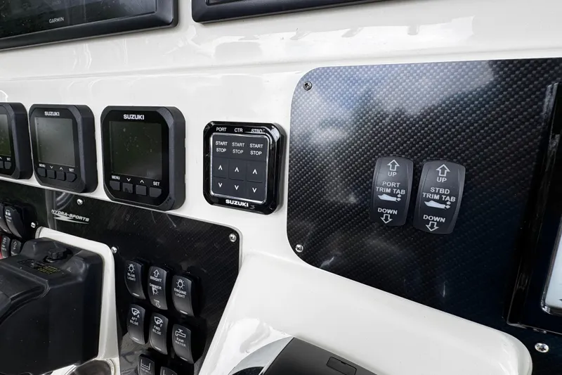  Yacht Photos Pics 2007 Hydra-Sports Vector 3300 VX dashboard with Suzuki controls and trim tab switches.