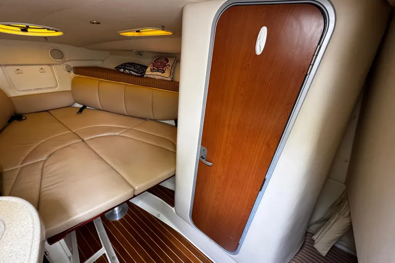  Yacht Photos Pics 2007 Hydra-Sports Vector 3300 VX cabin interior with beige seating and wooden door.