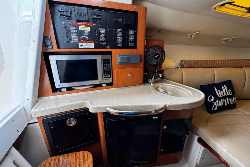  Yacht Photos Pics 2007 Hydra-Sports Vector 3300 VX cabin with kitchenette, microwave, and seating area.